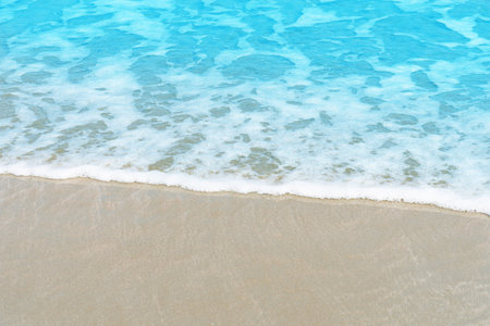 Soft blue ocean wave on sandy beach for texture copy space and backgroundの写真素材