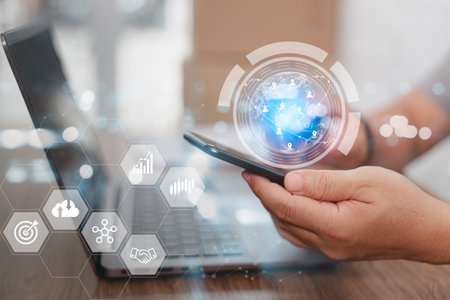 Business man use smartphone working in office are using creative ideas with connection technological in the internet world without borders and laptop on tableの写真素材