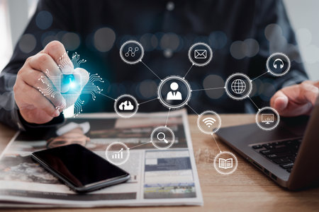 Businessman touching icon of media screen Digital transformation technology strategy concept, Businessman searches data from internet using his phone. and laptop with newspaper onの写真素材