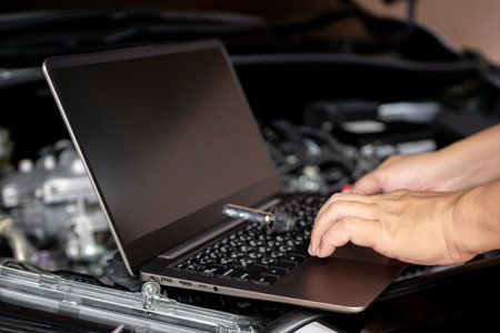 Car service and technology concept, Technicians use laptop check service lists for car part mistakes and maintenance in engine roomの写真素材