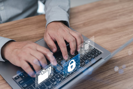 Businessman typing on a laptop with Increasing the security of document storage in online network and use it safely working in an officeの写真素材