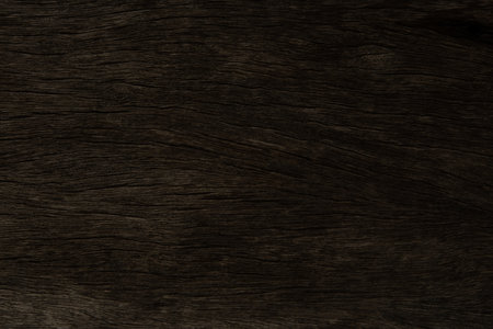Old dark brown wood wall crack pattern on the surface for background and textureの写真素材