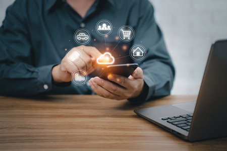 Man uses smartphone and laptop with cloud computing diagram show on hand. payment concept online with the internet and working in officeの写真素材