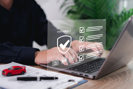Car dealer businessman use laptop,checklist and signing car insurance on smart document. Modern car loan and insurance concepts on virtual screens without documents.の写真素材