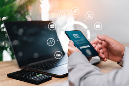 Online Payment And Biometric Identification Concept, Businessman use smartphone payment online in application secure online transactions on  internet Authentication by fingerprint scanning with laptopの写真素材