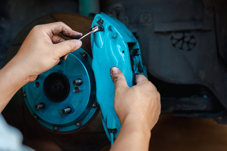 Technician check car brake calipers are inspected and the system is inspected for safety, Check the brake fluid and equipment malfunction ,car service concept and mainternanceの写真素材
