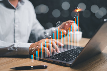 Businessman use laptop and analyzing financial information and calculating financial information for long-term for the development of a sustainable economic plan investments.developed in year 2024の写真素材