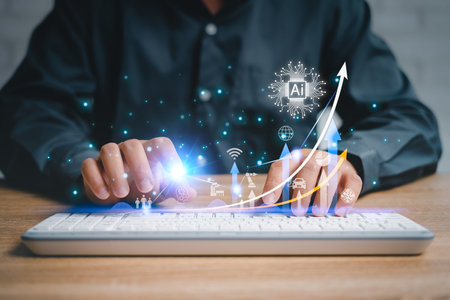 AI or Artificial intelligence growing concept, Businessman typing keyboard desktop with hologram technology business and industry growth graph digital marketing use AI technology for developmentの写真素材