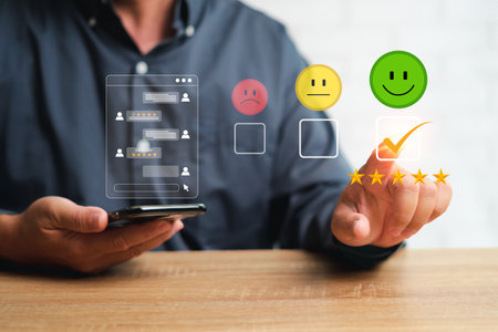 Customer Satisfaction Survey Concept, Businessman chat on smartphone with customer and check rate service experiences on the online application and pointing on 5 star ratting on virtual screensの写真素材