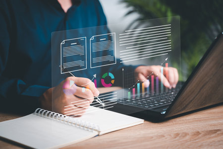Businessman use laptops to work on smart digital marketing on virtual screen,Analyzes the profitability of working companies with digital augmented reality graphics and save information in databaseの写真素材