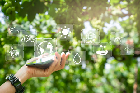 Agriculture technology farmer and environmental conservation modern concept, Close up hand of farmer use smartphone and computer analysis data visual icon about efficient farming and environmentalの写真素材
