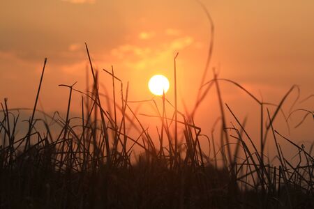 Warm mountains sunset with orange skyの写真素材