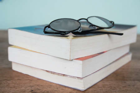 pile of reading books and spectacles