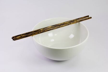 white bowl with black chopsticksの写真素材