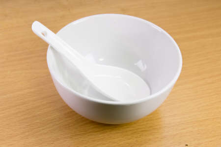 white bowl with spoonの写真素材