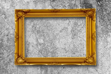 Old gold picture frame on grunge wall.の写真素材