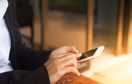 Close-up Of Woman's Hand Using Cell Phone or smartphoneの写真素材