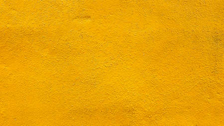 Concrete wall yellow color for texture backgroundの写真素材