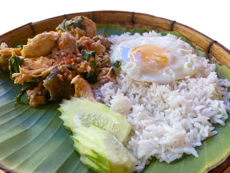 Rice topped with stir-fried pork or beef and basil for sale at Thai street food market or restaurant in Bangkok Thailandの写真素材