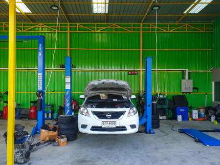 Bangkok, Thailand - July 17, 2021 : Unidentified car mechanic or serviceman checking a car engine for fix and repair problem at car garage or repair shopのeditorial素材
