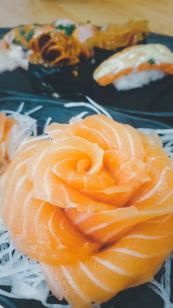 Japanese food delicacy consisting sashimi salmon of very fresh raw salmon fish sliced into thin pieces serving with radish sliced in japan restaurantの写真素材