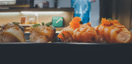 Japanese food in set different types of sushi with seaweed salad and gari (ginger) is a healthy food at the upper right of the serving board in japan restaurantの写真素材
