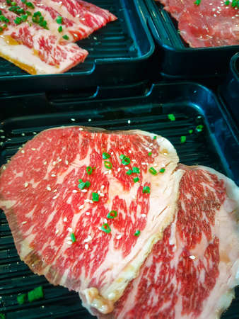 Grilled raw meat beef and pork (barbeque, bbq) a food cooking on wagyu grill in BBQ. yakiniku grill buffet restaurantの写真素材