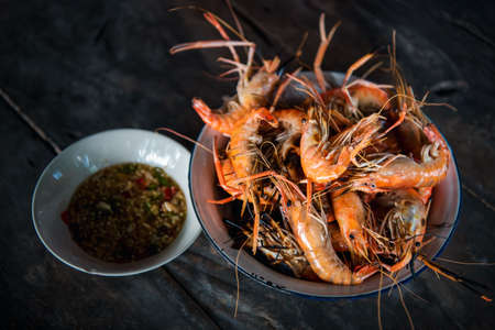 Grilled shrimp (Giant freshwater prawn) grilling with charcoal premium grade display for sale at Thai street food market or restaurant in Bangkok Thailandの写真素材