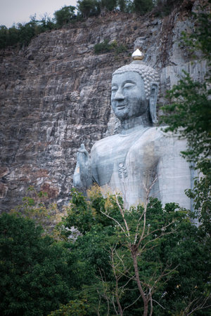 Bhutsaya Khiri Sri Suvarnabhumi is the name of a giant stone Buddha image in Suphanburi province that belongs to the nearby Buddhist temple Wat Khao Tham Thiamの写真素材