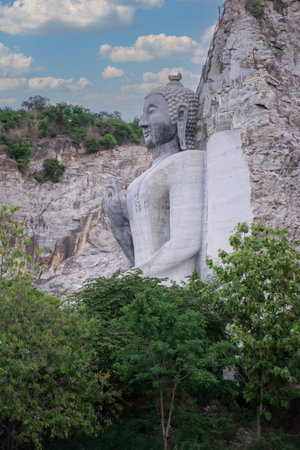 Bhutsaya Khiri Sri Suvarnabhumi is the name of a giant stone Buddha image in Suphanburi province that belongs to the nearby Buddhist temple Wat Khao Tham Thiamの写真素材