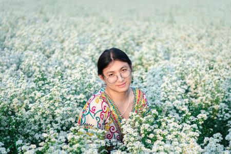 Beautiful asian woman natural makeup wear fashion relax clothes posing at nature of flower park or flower garden field lush growing for travel popular landmark in asia outdoor fashion styleの写真素材