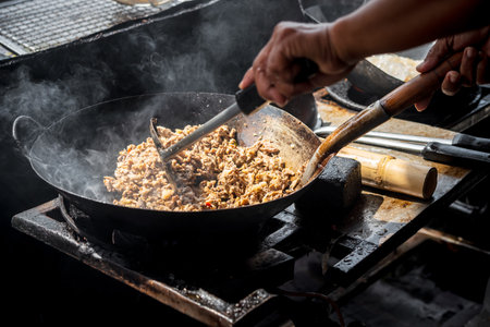 Rice topped with stir-fried pork or beef and basil for sale at Thai street food market or restaurant in Bangkok Thailandの写真素材