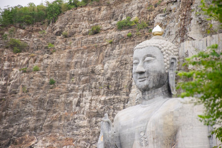 Bhutsaya Khiri Sri Suvarnabhumi is the name of a giant stone Buddha image in Suphanburi province that belongs to the nearby Buddhist temple Wat Khao Tham Thiam Suphanburi, Thailandの写真素材