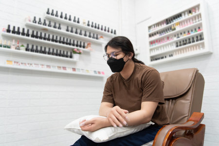 Beautiful asian woman (LGBTQ) do a manicure or pedicure at nails hand and foot in fashion nail style by nail technician with gel nails or acrylic at nail salon or beauty salon.の写真素材