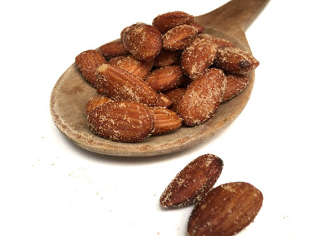 Almonds with salt and wood spoon on white backgroundの素材