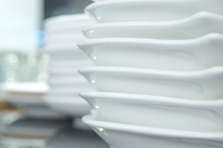 Close up of plates stacking in the restaurant,pile,indoorの写真素材