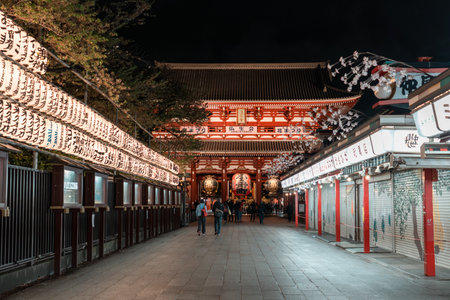 TOKYO, JAPAN - APRIL 7, 2023: People walking around Senso-ji temple in Asakusa area in the evening with rain drizzleのeditorial素材