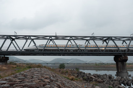 SHIZUOKA, JAPAN - APRIL 6, 2023: Tokaido Shinkansen crossing Fuji View Shinkansen rail bridge in the eveningのeditorial素材