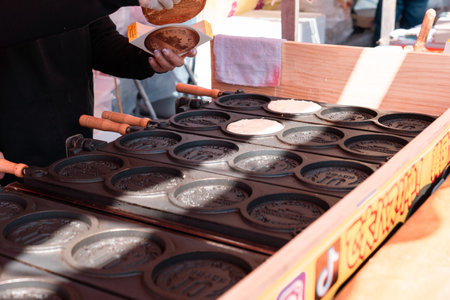 TOKYO, JAPAN - APRIL 9, 2023: Vender selling 10Yen coin shape pancake with mozzarella cheese in Sensoji templeのeditorial素材