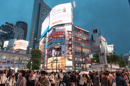 TOKYO, JAPAN - APRIL 8, 2023: View of Shibuya Crossing, one of the busiest crosswalks in the world in a raining dayのeditorial素材