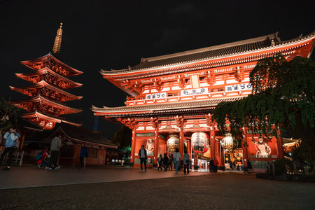 TOKYO, JAPAN - APRIL 7, 2023: People walking around Senso-ji temple in Asakusa area in the evening with rain drizzleのeditorial素材