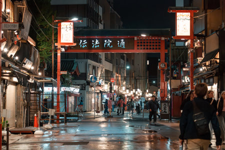 TOKYO, JAPAN - APRIL 7, 2023: People walking around Senso-ji temple in Asakusa area in the evening with rain drizzleのeditorial素材