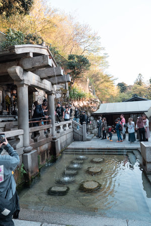 KYOTO, JAPAN - April 3, 2023: Tourist washing hands and mouth at Otowa waterfall at Kiyomizu-dera templeのeditorial素材