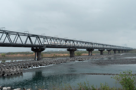 SHIZUOKA, JAPAN - APRIL 6, 2023: Tokaido Shinkansen crossing Fuji View Shinkansen rail bridge in the eveningのeditorial素材