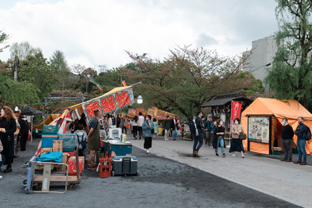 TOKYO, JAPAN - APRIL 8, 2023: Street food venders at Ueno park selling food to peopleのeditorial素材