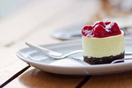 The strawberries cheesecake on the table with soft lightの写真素材