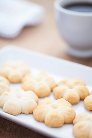 The butter cookies on the long dish with a cup of coffeeの写真素材
