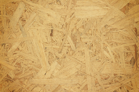 Sheet of plywood with fragments of compressed sawdust