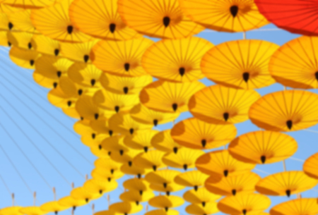 Blur Colorful umbrellas beautiful hanging from creating feeling of floating umbrellas.