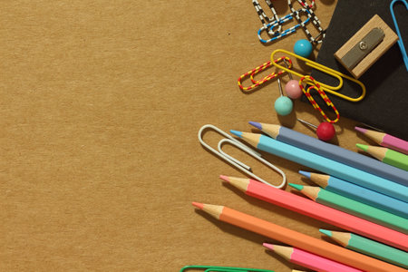 School supplies on paper brown background ready for your design.